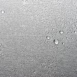 Brushed metal surface with water drops